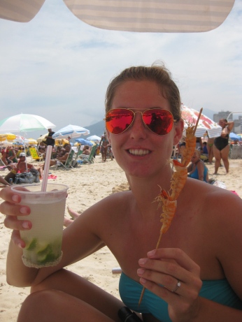 Enjoying a prawn skewer and caipirinha on the beach
